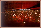 ... devotees engaged in performing the mass arti