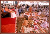 Swamishri and devotees perform arti during the bhumi pujan ceremony for a large assembly hall on the mandir grounds