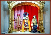 Shri Harikrishna Maharaj adorned in chandan and Shri Radha Krishna Dev