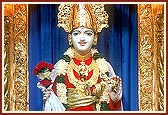 Shri Ghanshyam Maharaj attired for the occasion of Amas with swords, daggers and shields