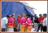Prior to their performance, kishores pray behind the main stage