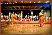 Swamishri performs arti of the murtis, blesses everyone by showering rice grains and addresses the assembly