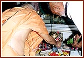 Swami performs abhishek of Shivling with milk on the first day of the holy month of Shravan