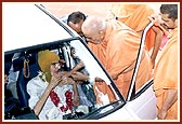 Swamishri garlands and blesses an ailing devotee