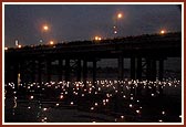 Children offer reverence by setting afloat thousands of diva into the river Sabarmati