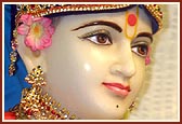 Bhagwan Swaminarayan beautifully decorated with a crown, earrings and necklaces