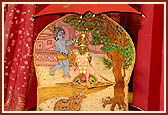Shri Harikrishna Maharaj with an umbrella to shelter Him from the rain