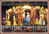Swamishri sanctifies rakhdis to be tied on the wrists of devotees with a shower of petals