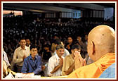Devotees file past as they do darshan and receive Swamishri's blessings after the Rakshabandhan assembly&nbsp;&nbsp;