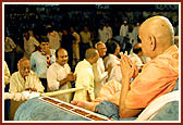 Devotees file past as they do darshan and receive Swamishri's blessings after the Rakshabandhan assembly&nbsp;&nbsp;