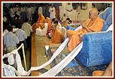 Devotees file past as they do darshan and receive Swamishri's blessings after the Rakshabandhan assembly&nbsp;&nbsp;
