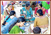 Devotees enjoy the prasad served in the mandir precincts after the Rakshabandhan assembly