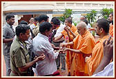 Swamishri initiates the security police into the Satsang-fold