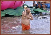 Swamishri takes the customary bath