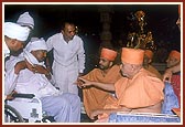 Swamishri individually blesses and consoles the relatives of those who had died