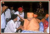 Swamishri individually blesses and consoles the relatives of those who had died