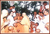 Swamishri interacts with a youth at the back of the mandir pradakshina