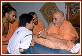 Swamishri meets, listens to, advises and blesses a local balak 