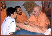 Swamishri meets, listens to, advises and blesses a local balak 