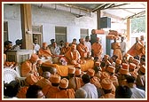 While waiting for the arti, Swamishri and others listen to one the resident sadhus narrating the divine lila of Shriji Maharaj