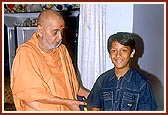 Swamishri blesses a local kishore