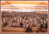 Devotees seated in the murti pratishtha assembly