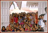 Women devotees seated in the murti pratishtha ceremony