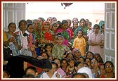 Women devotees seated in the murti pratishtha ceremony