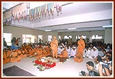 Devotees perform the murti pratishtha arti