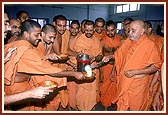 Swamishri serves to sadhus in dining hall