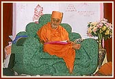 Swamishri writes blessings in the mandir account book