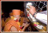 The trustees of the mandir honor Swamishri with garlands