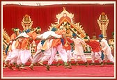 Tribal devotees perform a traditional dance to please Swamishri