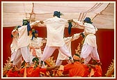 Tribal devotees perform a traditional dance to please Swamishri