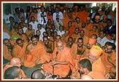 Swamishri sits with the sadhus and enjoys with them
