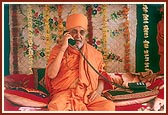 Blesses a devotee on the phone