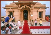Swamishri blesses a disabled devotee prior to his departure