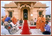 Swamishri blesses a disabled devotee prior to his departure