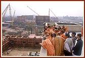 Swamishri and sadhus observe the under construction Akshardham complex