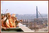 Swamishri and sadhus observe the under construction Akshardham complex