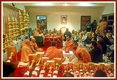 During Swamishri's morning puja, the pujan rituals for the kalashas and flagstaffs are being performed