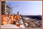 Swamishri observes other areas of the Akshardham complex from the monument itself
