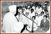 Swamishri blesses the satsang assembly held in an open area by the Radhakrishna mandir, 20 January 1976
