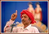 A satsangi tribal volunteer speaks to the assembly