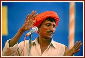A satsangi tribal volunteer addresses the assembly