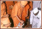 Swamishri blesses children during his visit to a house sanctified by Shastriji Maharaj