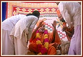 Swamishri happily blesses the veteran devotees and their children