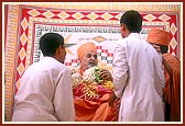 Swamishri happily blesses the veteran devotees and their children