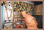Swamishri doing darshan of murtis in the mandir