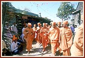 Swamishri walks through the village